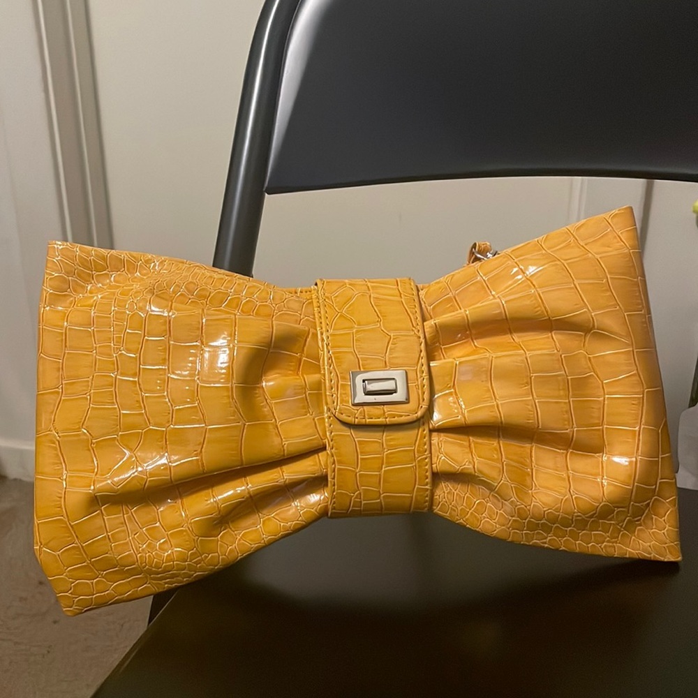 Yellow clutch purse with silver buckle